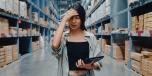 Women in warehouse frustrated and wondering how to be more flexible with supply chain disruptions