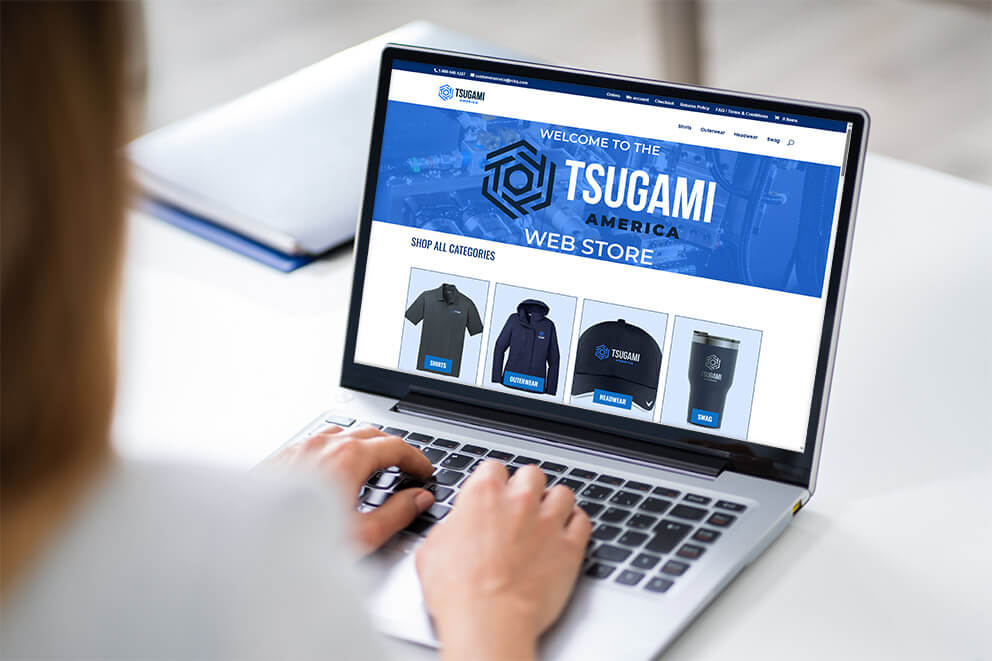 Close-up of a person from Righteous Clothing Agency browsing the Tsugami America web store, with displayed branded merchandise.