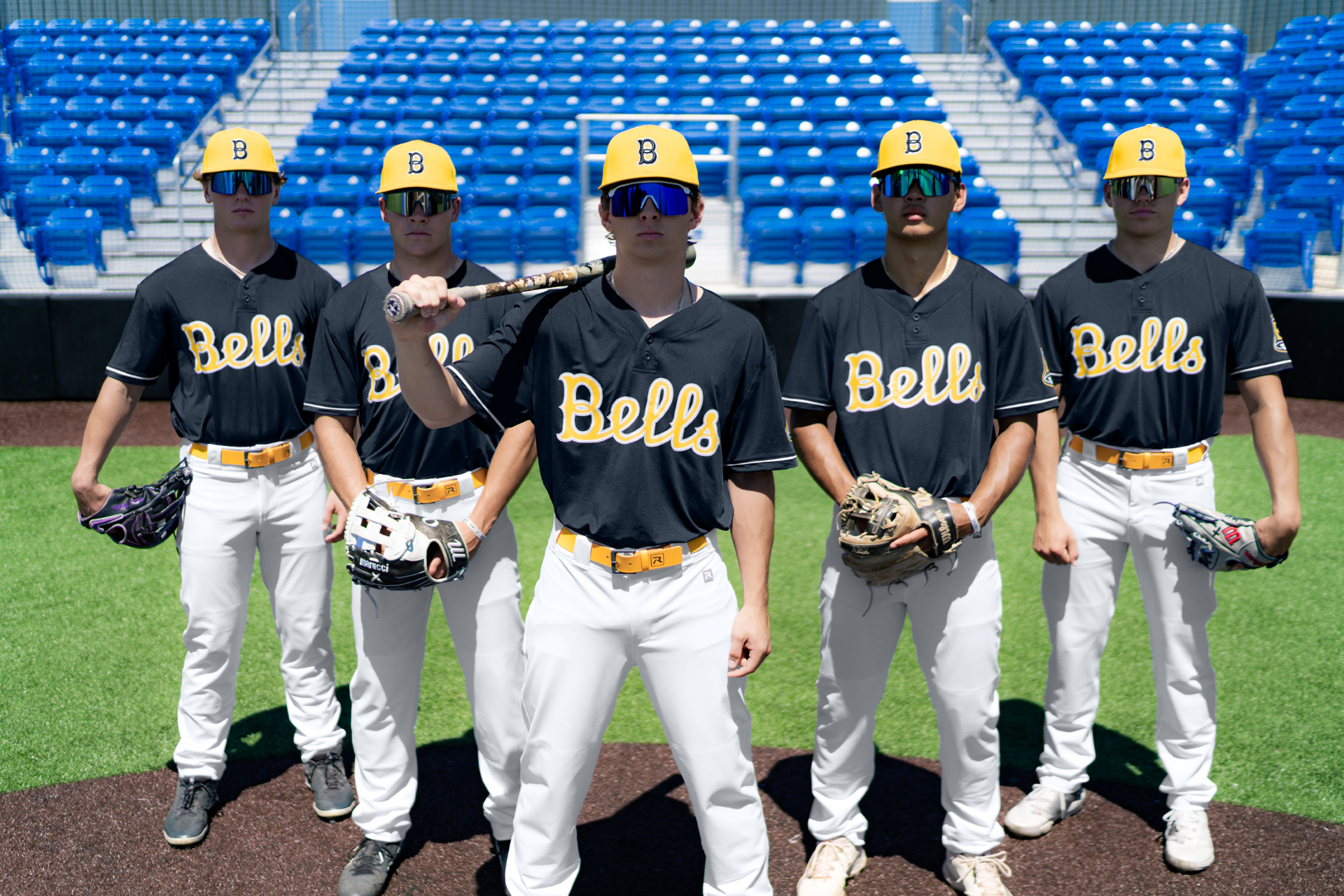 Baseball team in custom uniforms with breathable fabric and front lettering from Righteous Clothing Agency on the field.
