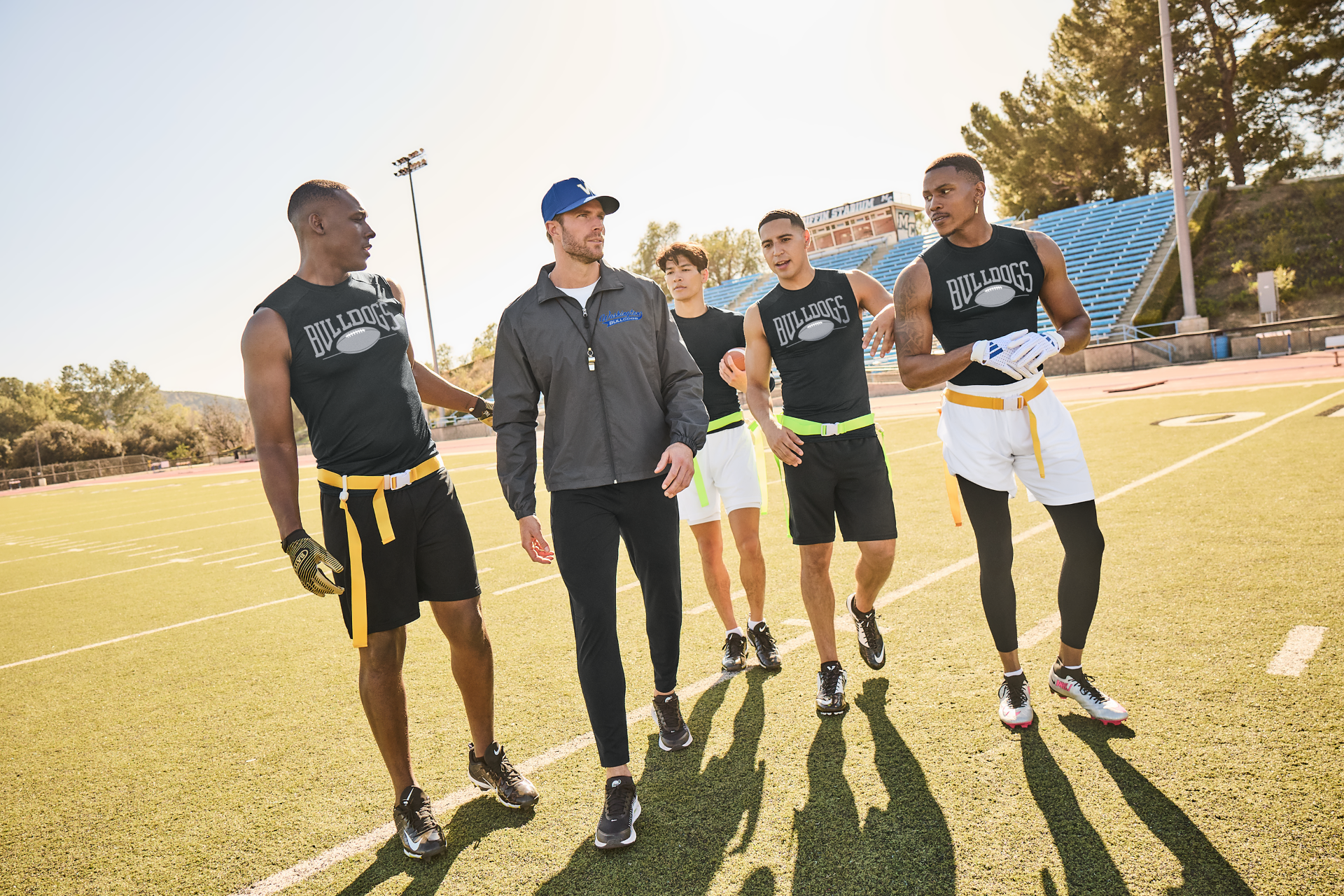 Righteous Clothing Agency outfits coach and players in team gear during a walk on the football field.