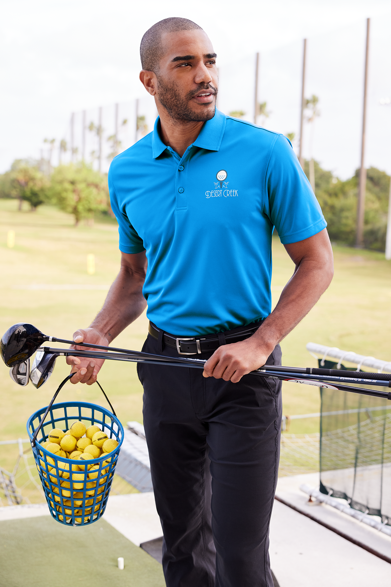 Golfer wearing a blue performance polo with breathable fabric from Righteous Clothing Agency.