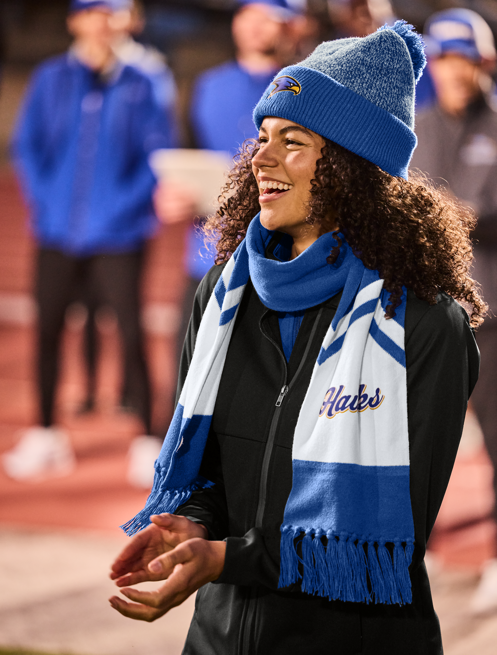 Righteous branded beanie and scarf worn at a team sports event outdoors.