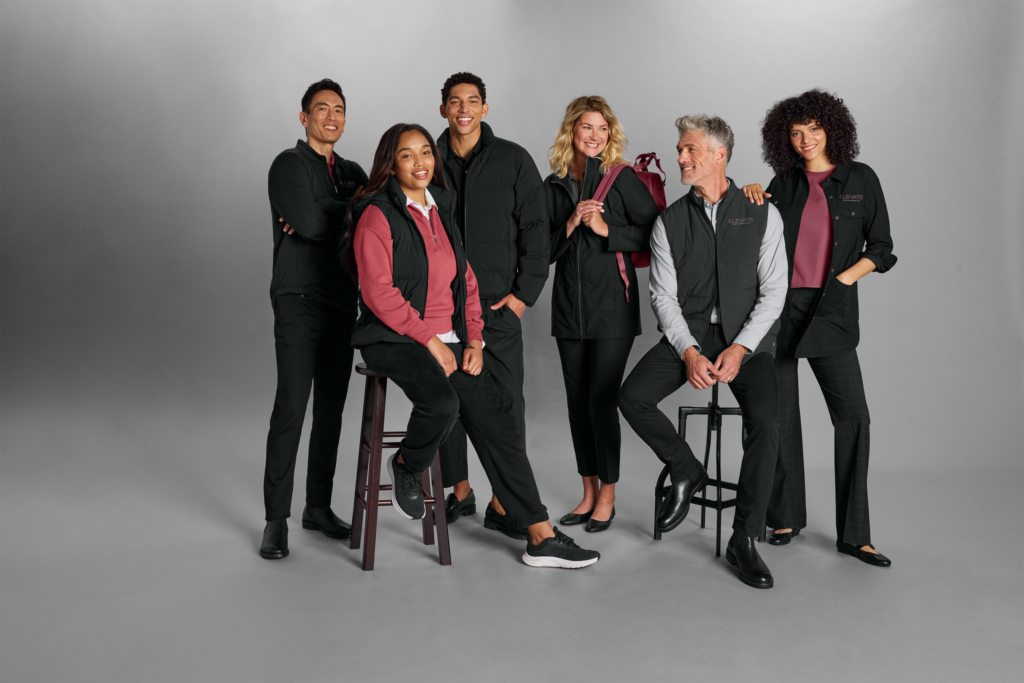Diverse team wearing Righteous-branded corporate uniforms in coordinated black and burgundy.