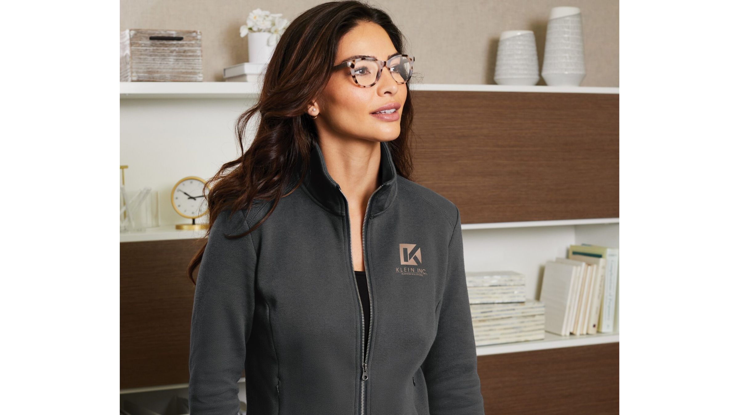 Righteous branded gray zip-up jacket worn in a polished office setting.