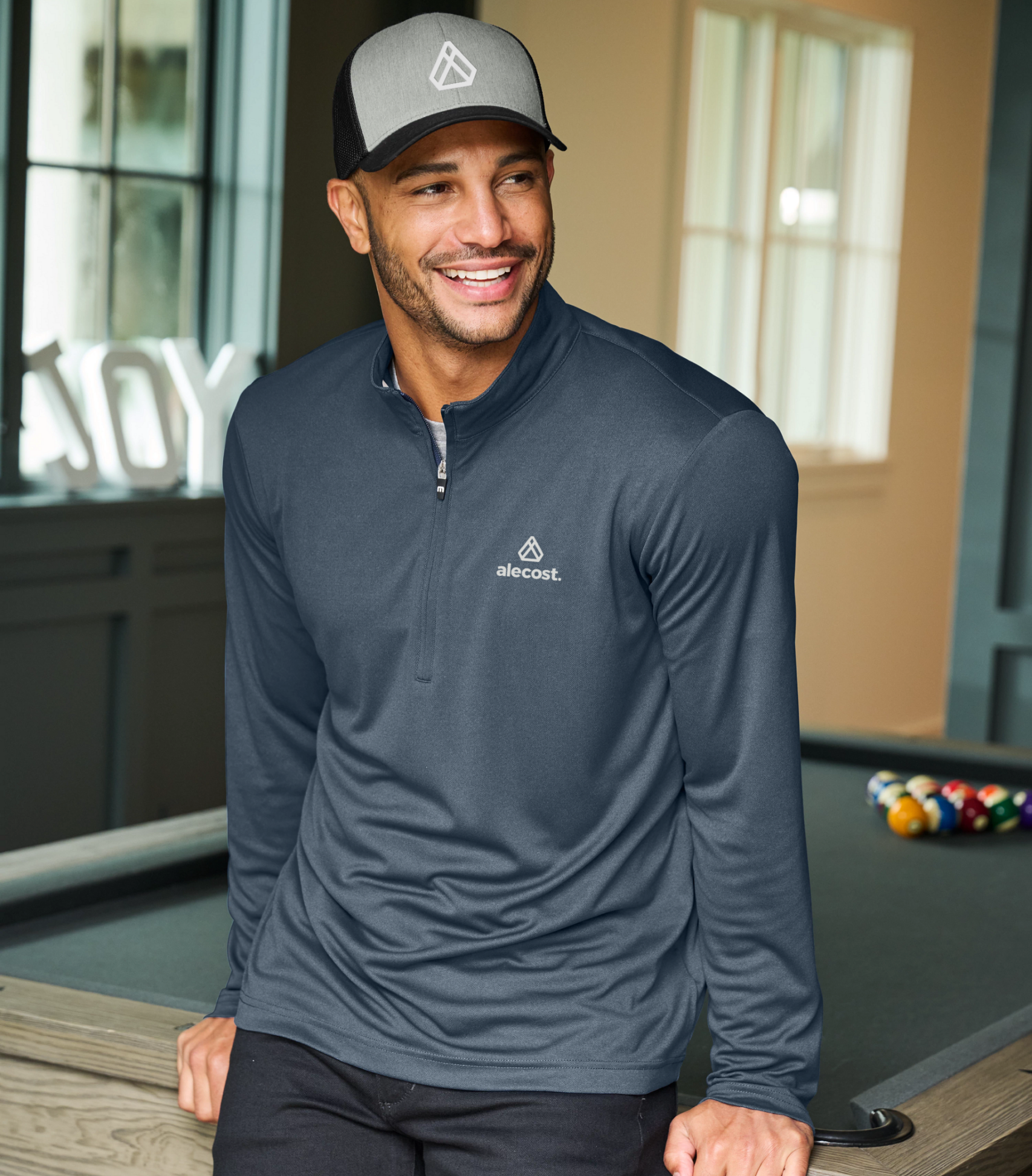 Righteous branded quarter-zip and cap worn in a casual indoor setting.