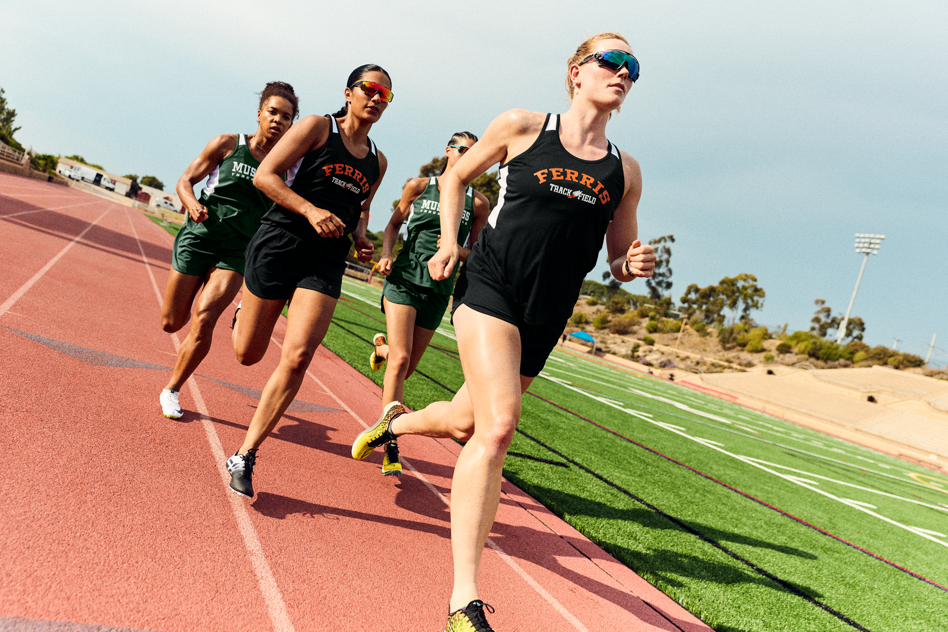 Track athletes in branded uniforms supplied by Righteous Clothing Agency. 
