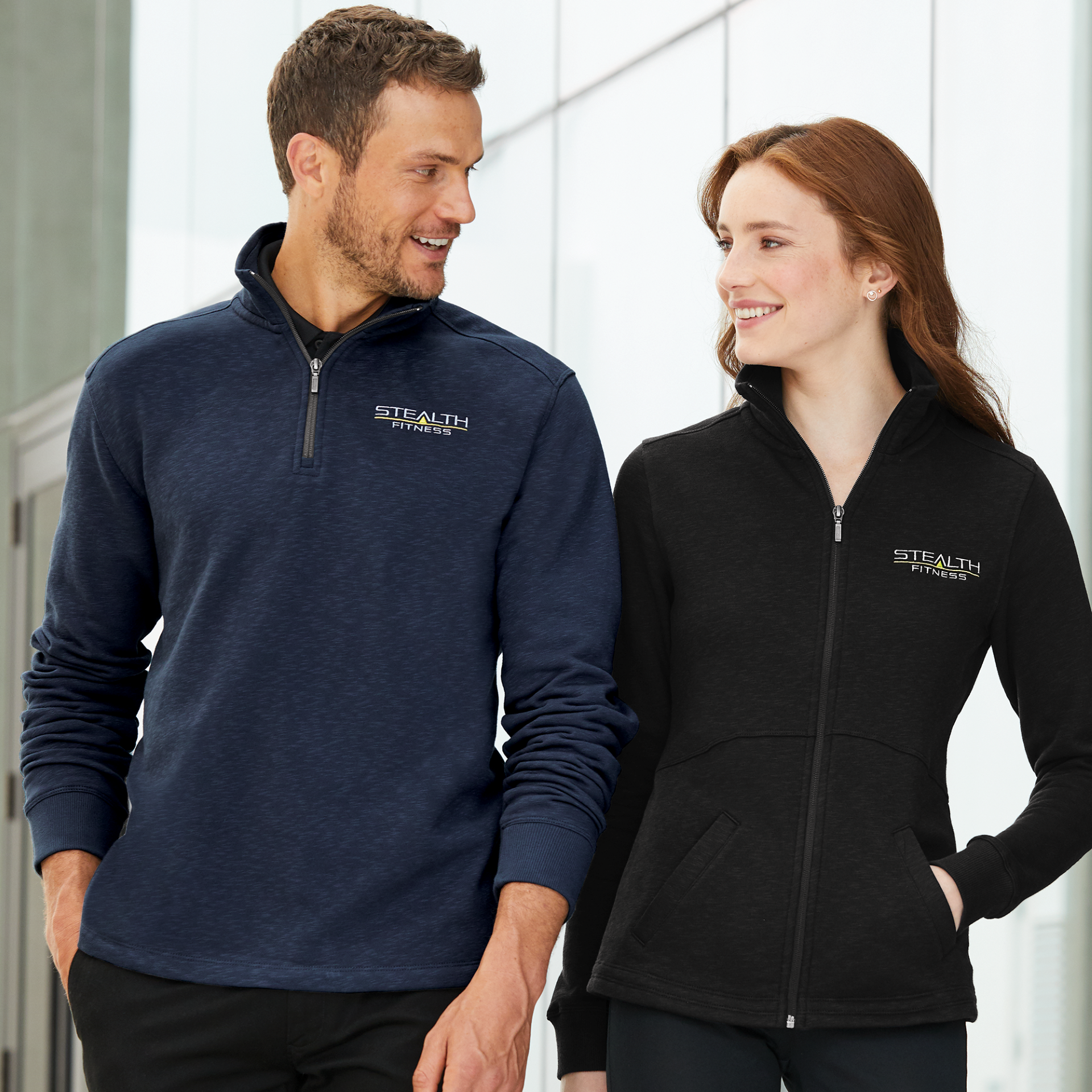 Righteous branded fleece uniforms worn by two fitness staff members indoors. 