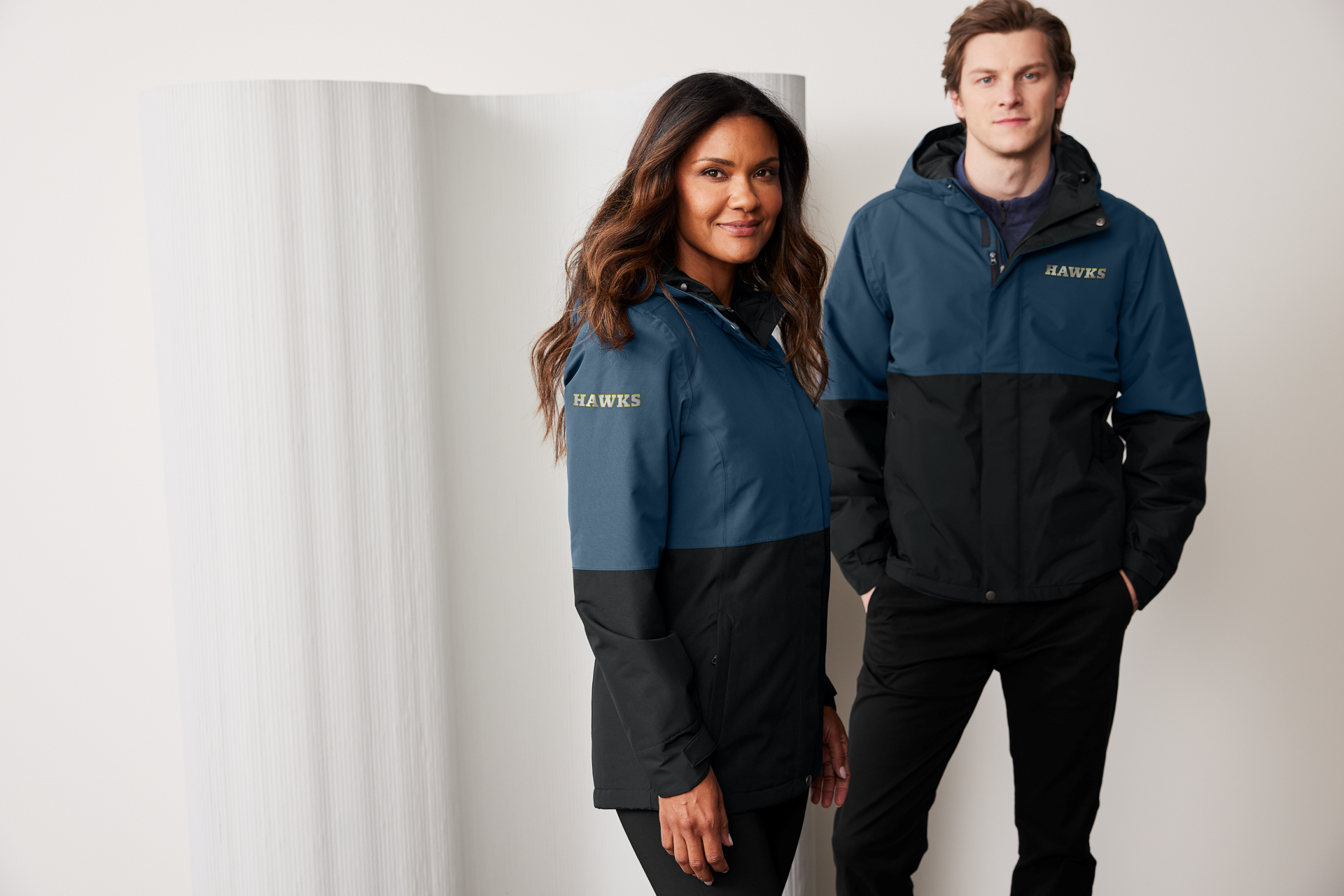 Two employees in branded jackets supplied by Righteous Clothing Agency.