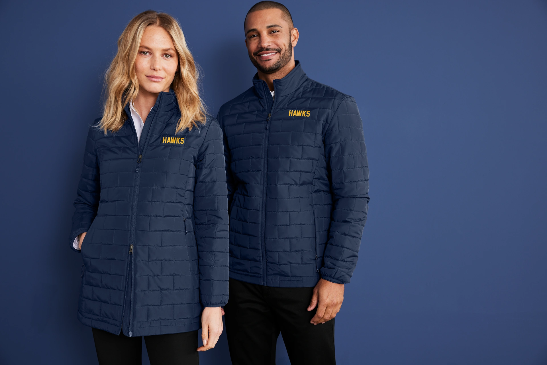 Two models wear Righteous custom-branded navy quilted jackets with Hawks logos.
