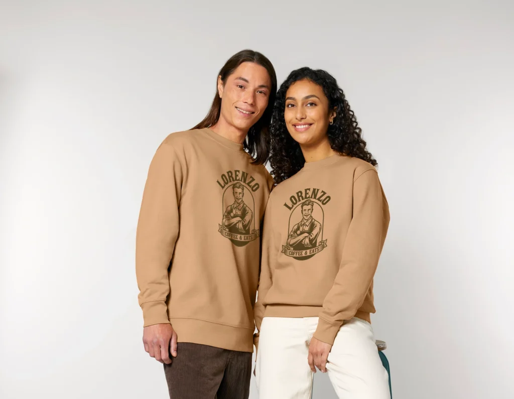 Two models wear matching tan graphic sweatshirts from Righteous Clothing Agency.