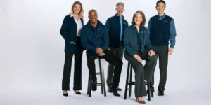 Five team members in branded navy apparel from Righteous posed together on a white background for a professional team portrait.
